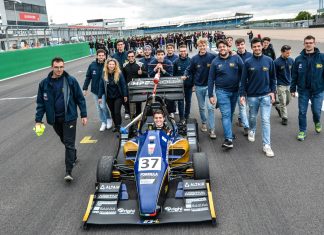 The 40 year old (Formula Student) virgin MoRe Modena Racing team members walking behind their car on the pit straight of Silverstone circuit